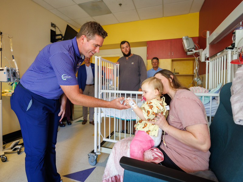 2023 Sanderson Farms Championship winner Luke List visits Children's of Mississippi patient Charlotte Stringer of Foxworth.